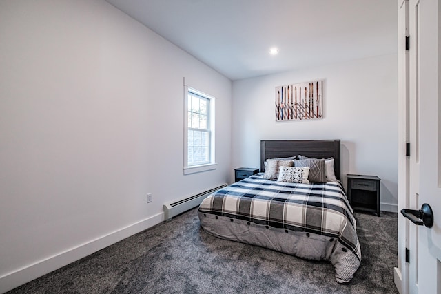 bedroom featuring a baseboard heating unit and dark carpet