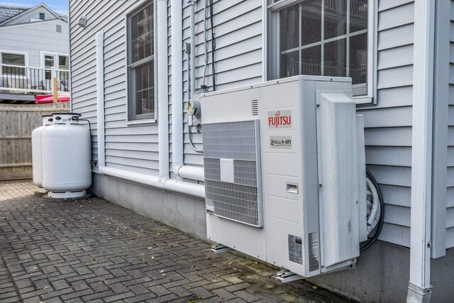 9 Robert Ln, Wells, ME 04090 - exterior view of heating fuel tank, fence, and a cooling unit