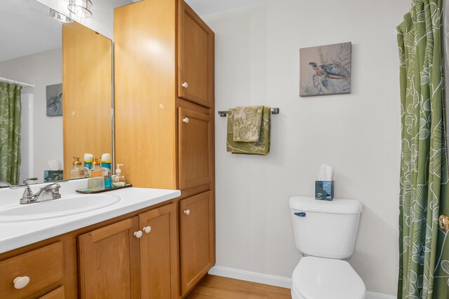 9 Robert Ln, Wells, ME 04090 - full bath featuring baseboards, toilet, wood finished floors, and vanity