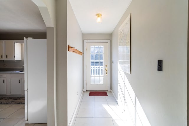 doorway to outside with light tile patterned floors