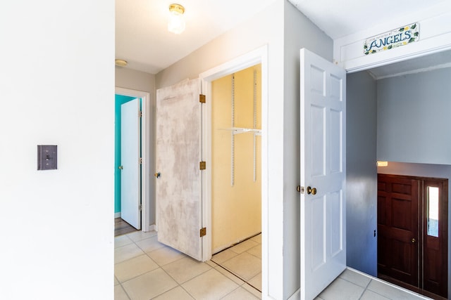 hallway featuring light tile patterned floors