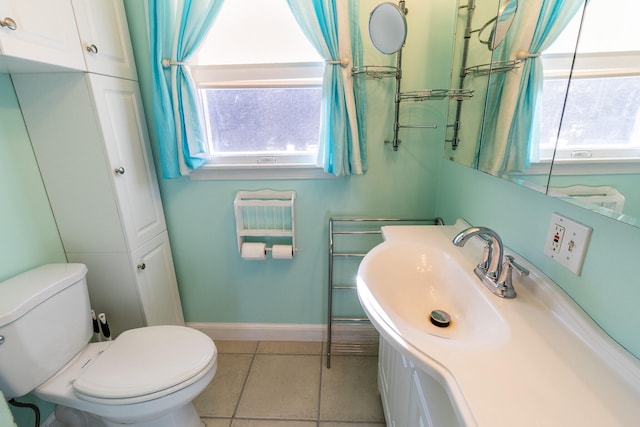 bathroom with vanity, toilet, and tile patterned flooring