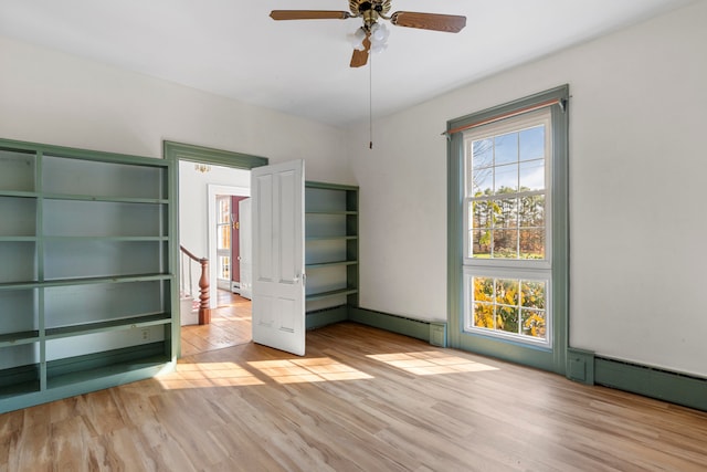 unfurnished bedroom featuring light hardwood / wood-style floors and ceiling fan