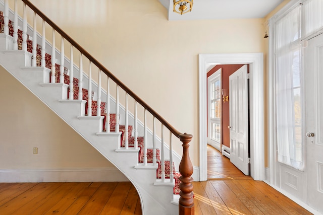 entryway featuring hardwood / wood-style floors, a healthy amount of sunlight, and a baseboard radiator