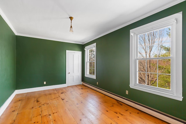 unfurnished bedroom with ornamental molding, a baseboard heating unit, light hardwood / wood-style flooring, and multiple windows