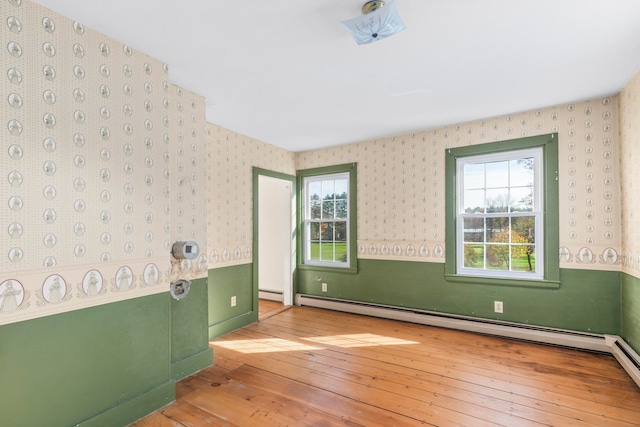 unfurnished bedroom featuring light hardwood / wood-style floors and baseboard heating