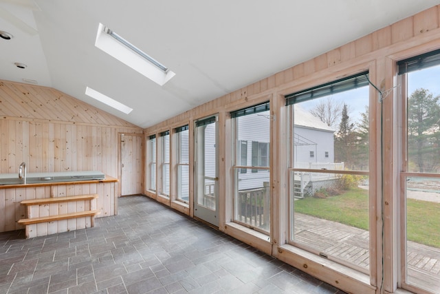 interior space with lofted ceiling with skylight and a healthy amount of sunlight