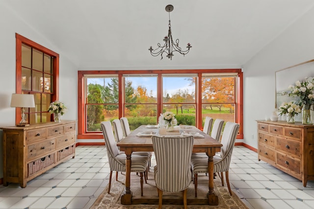 dining room featuring vaulted ceiling and an inviting chandelier