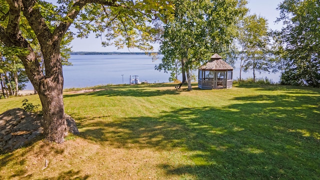 view of yard featuring a gazebo and a water view