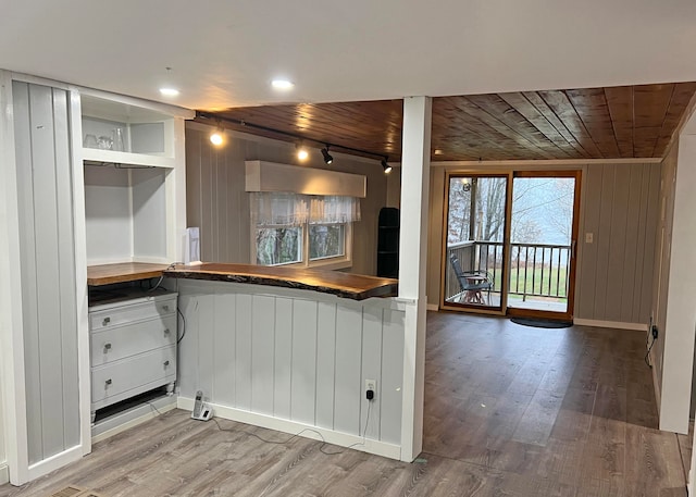 kitchen featuring wood ceiling, white cabinetry, wooden walls, and wood-type flooring