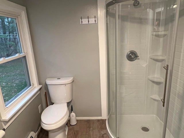 bathroom featuring toilet, hardwood / wood-style floors, and walk in shower