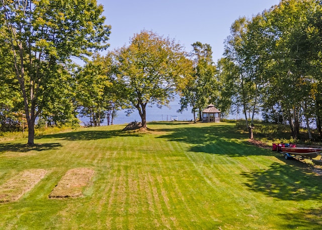 view of yard featuring a gazebo and a water view