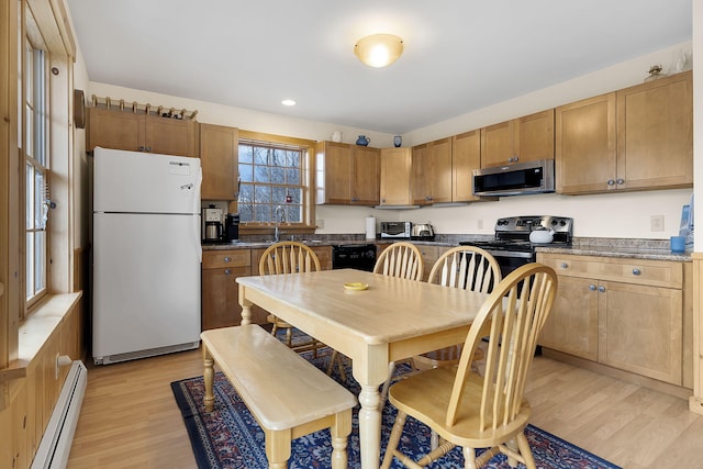 kitchen featuring black appliances, a baseboard radiator, light wood-style floors, dark countertops, and recessed lighting
