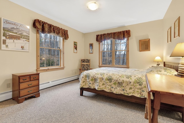 bedroom with carpet flooring and a baseboard heating unit