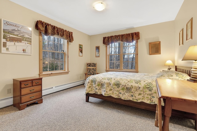 bedroom featuring a baseboard heating unit, multiple windows, and carpet floors