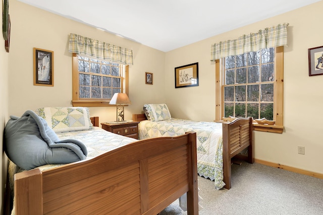 carpeted bedroom featuring baseboards
