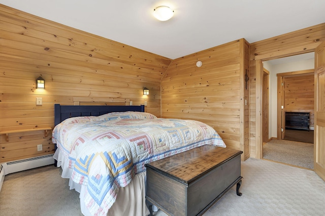 carpeted bedroom with wood walls and a baseboard heating unit