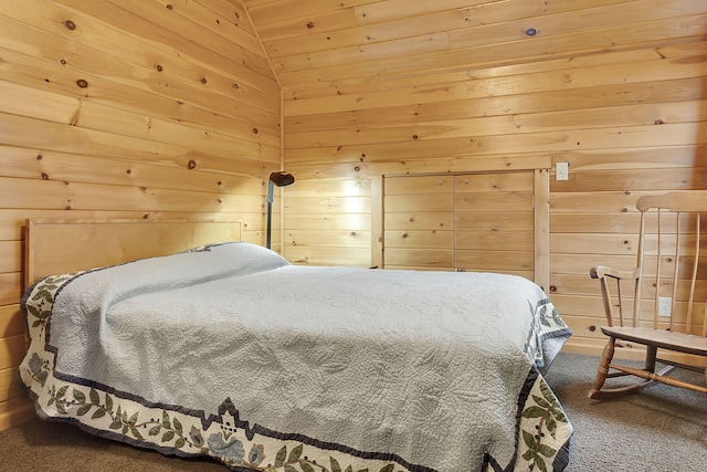 bedroom featuring carpet flooring, wooden walls, and vaulted ceiling