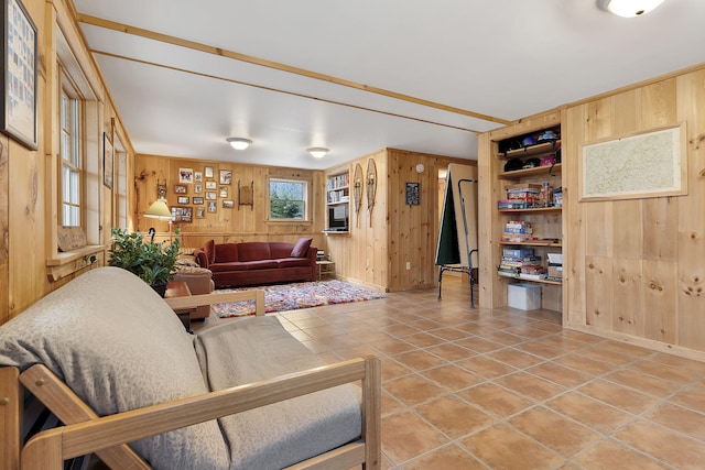 tiled living room featuring built in features and wooden walls