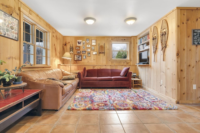 tiled living room featuring wooden walls