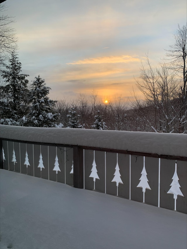 view of snow covered back of property