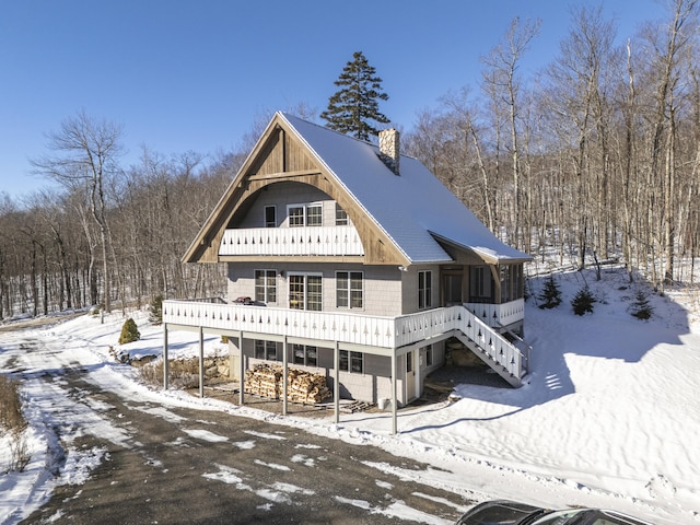 view of snow covered rear of property