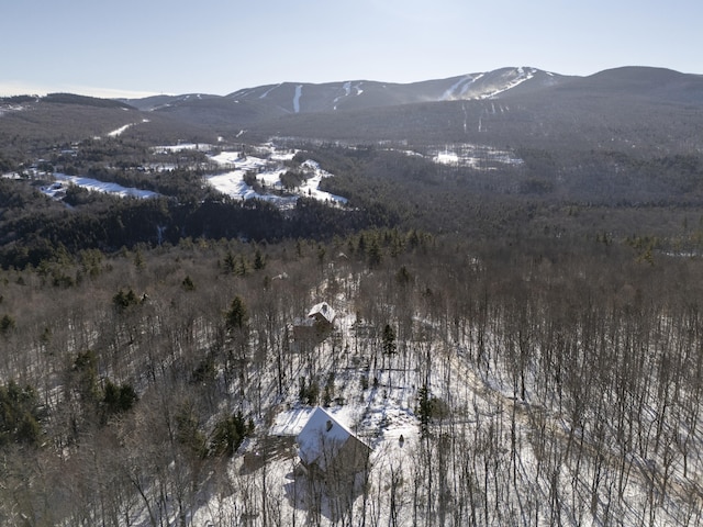 snowy aerial view with a mountain view