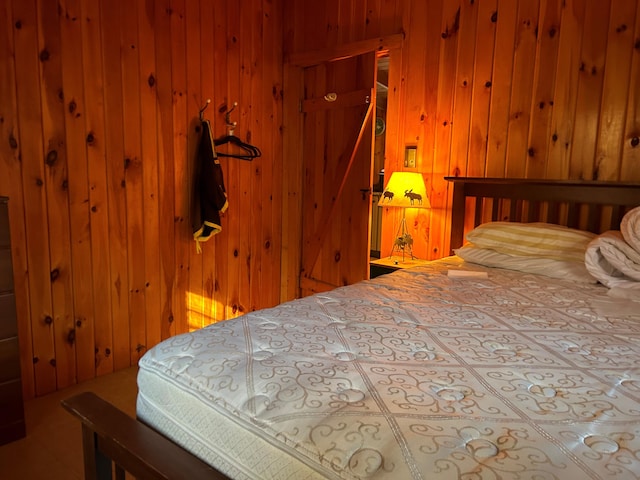 bedroom with wood walls