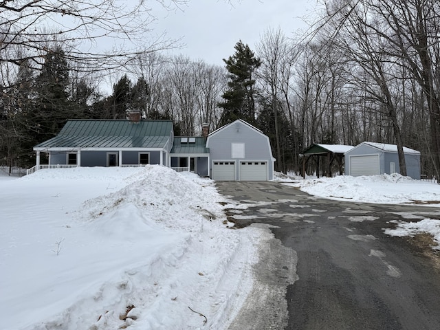 view of front of home with a standing seam roof, metal roof, a chimney, and a gambrel roof