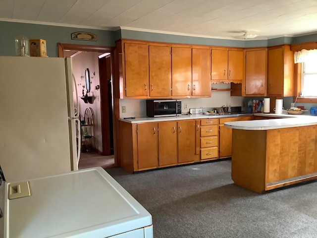 kitchen with white refrigerator, dark colored carpet, ornamental molding, and washer / dryer