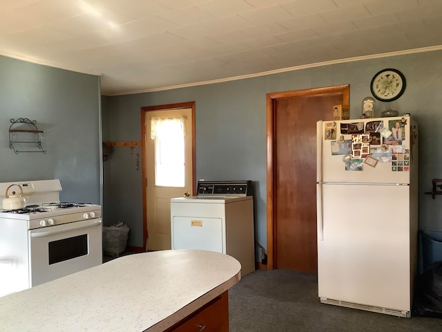 kitchen with ornamental molding, washer / clothes dryer, white appliances, and dark carpet