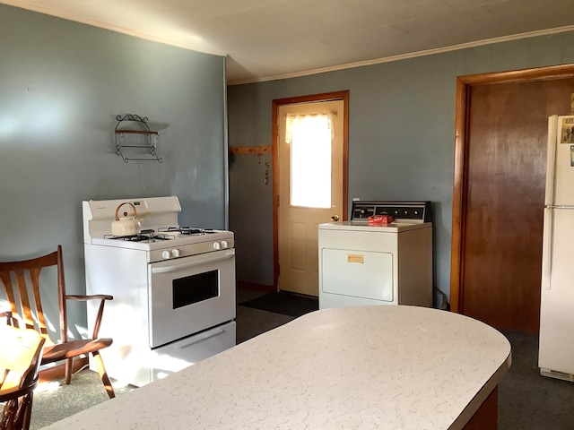 kitchen with white appliances, dark colored carpet, crown molding, and washer / dryer