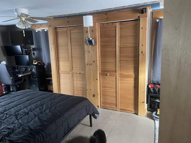 bedroom with two closets and ceiling fan