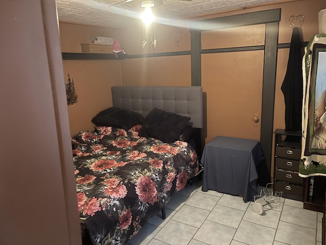 bedroom with ceiling fan and light tile patterned floors