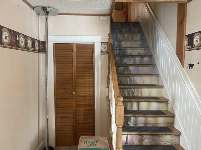 staircase featuring ornamental molding