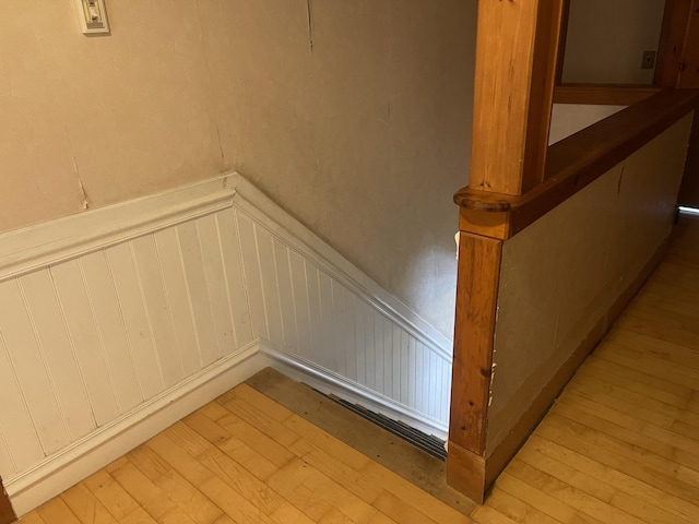 stairs with hardwood / wood-style floors