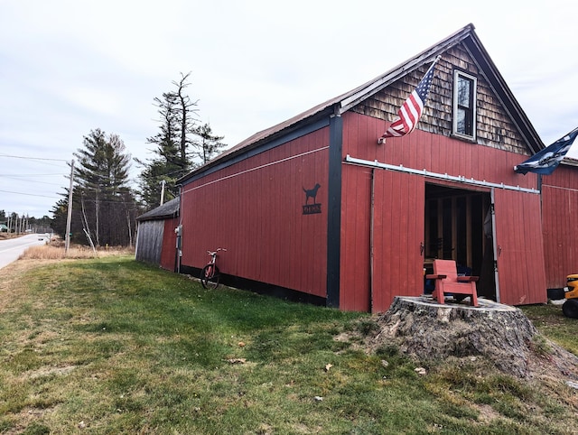 view of outbuilding featuring a lawn