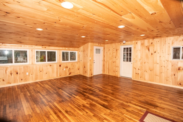 interior space with wood walls, wood-type flooring, and wood ceiling