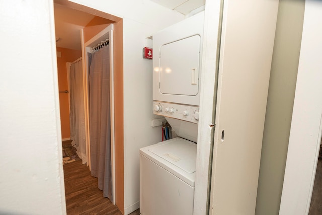 clothes washing area with stacked washer and dryer and dark hardwood / wood-style floors