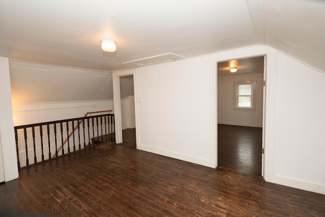 bonus room with vaulted ceiling and dark hardwood / wood-style flooring