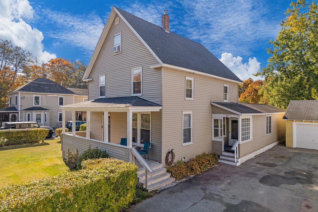18 Garrison St, Brunswick, ME 04011 - view of front of house with a front yard, a porch, and a garage