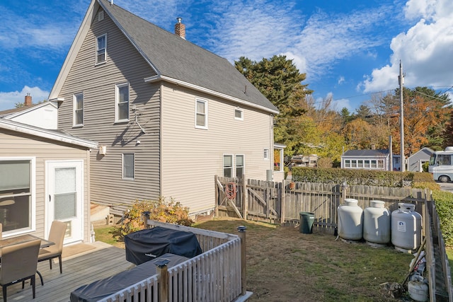 back of house with a wooden deck