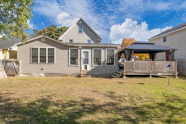 back of house featuring a yard and a gazebo