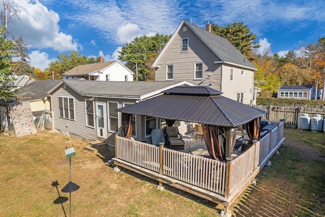 back of house with a gazebo, a wooden deck, an outdoor hangout area, and a yard