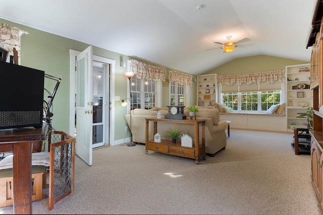 living room with vaulted ceiling, light colored carpet, and ceiling fan