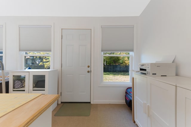 doorway with light colored carpet