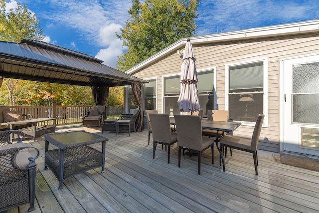 wooden deck featuring a gazebo and outdoor lounge area