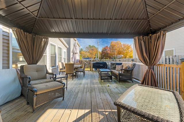 wooden deck with a gazebo and an outdoor living space