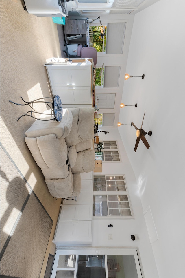 unfurnished living room featuring a towering ceiling and ceiling fan