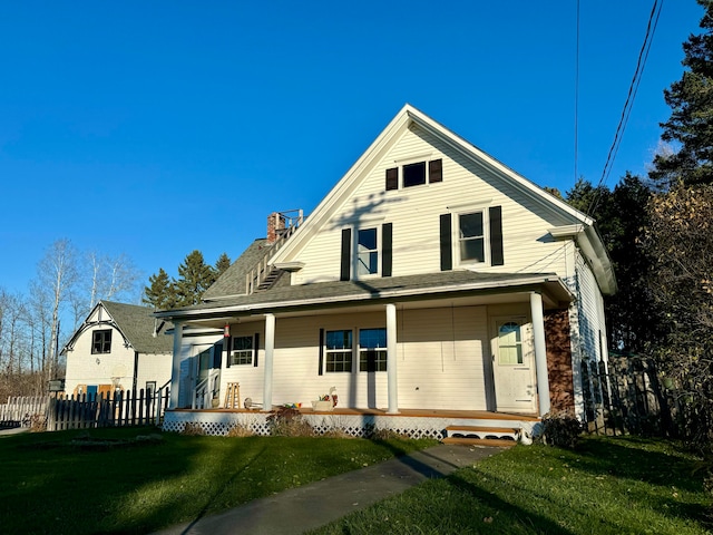 view of front of property with a porch and a front lawn